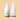 An image of two Bea's Bayou skincare products on a beige background. The left product, a 2.7 fl. oz. Good Biome Scalp Relief Solution with probiotic bioactives in a white bottle with a dropper, tackles itchy flakes. The right product is a 2 fl. oz. Good Biome Facial Renew Essence in a white spray bottle with a pink and purple label.